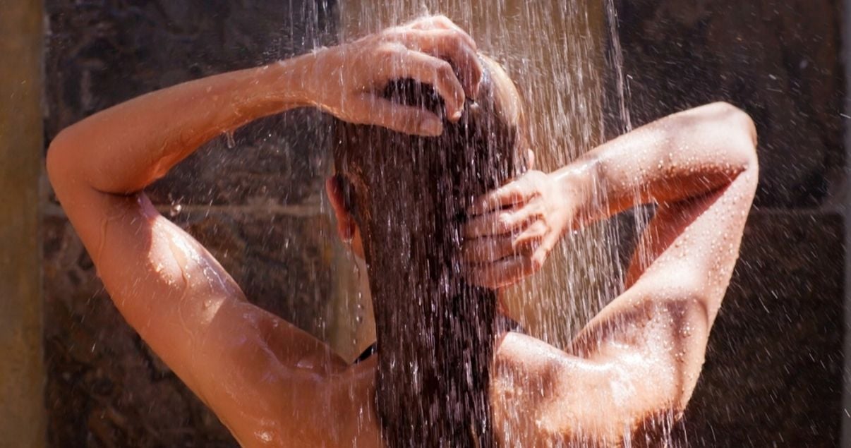 mature woman using shampoo safe for hairpiece and conditioner