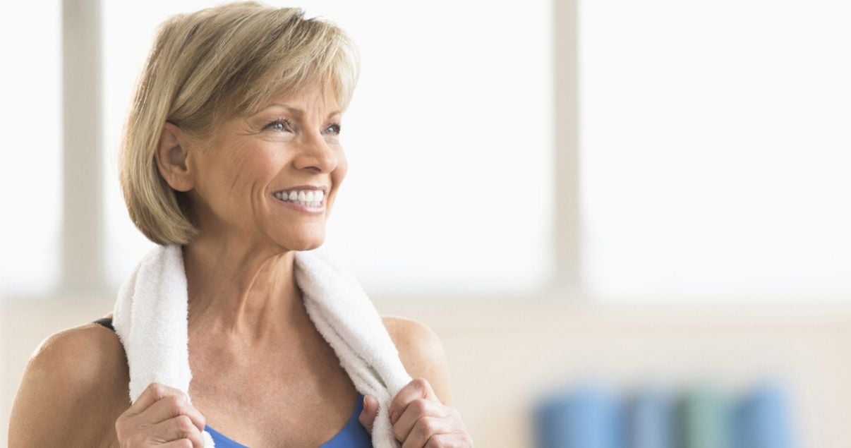 mature woman working out with hair system with towel
