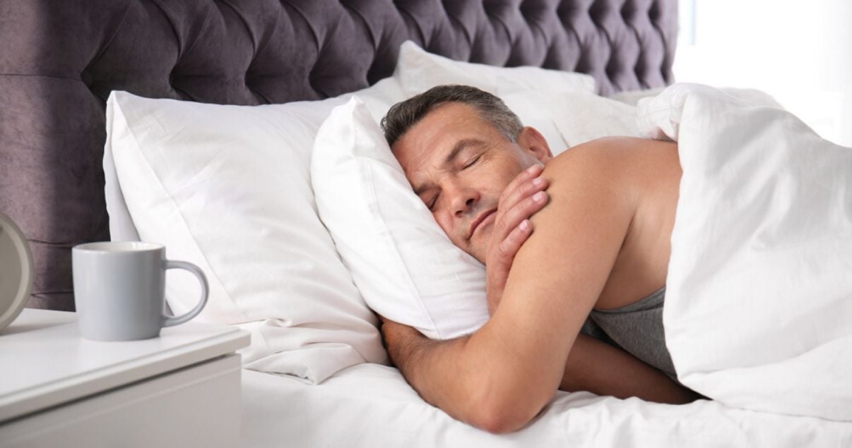 middle aged man sleeping comfortably in his hairpiece