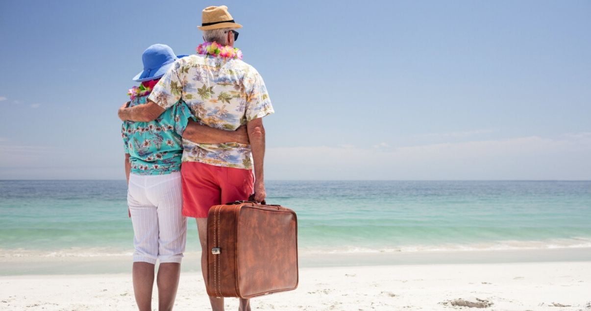 mature couple traveling with hairpieces at the beach on vacation