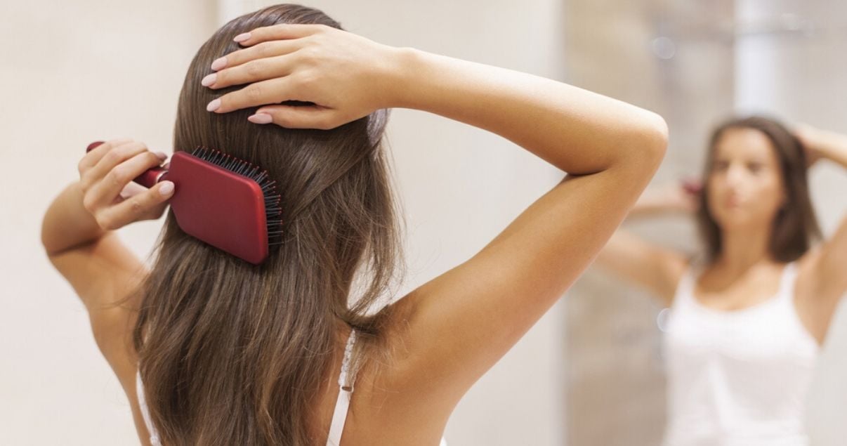 middle aged woman practicing DIY hair system maintenance