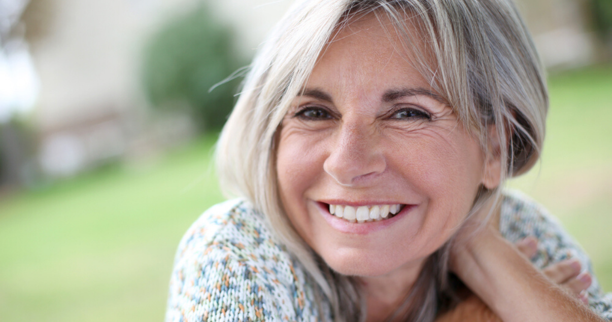 mature blonde woman enjoying her new hair system style