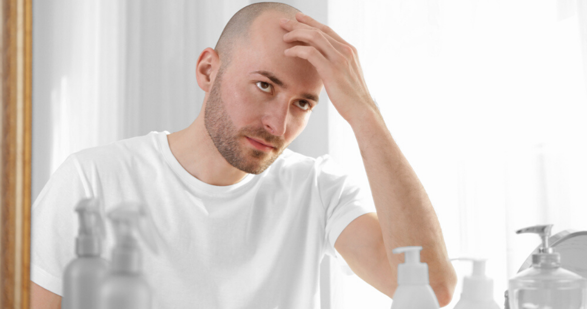 mature man following scalp maintenance advice by massaging scalp 