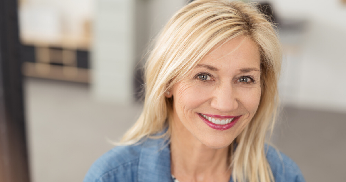 Middle aged woman happy with her soft hair system after using leave in conditioner