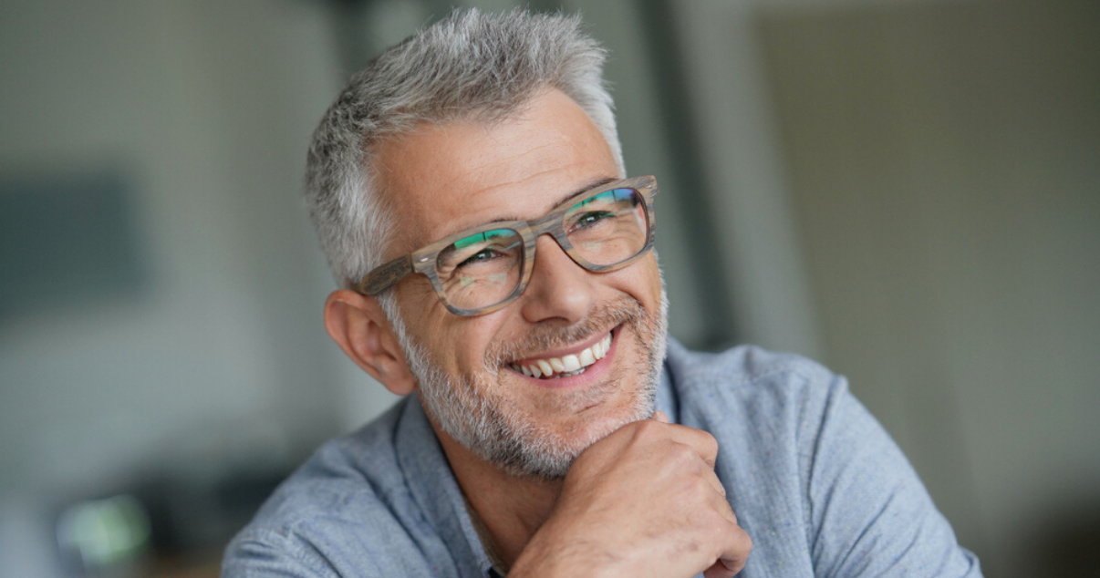 Middle aged man happy with stock hairpiece hair system