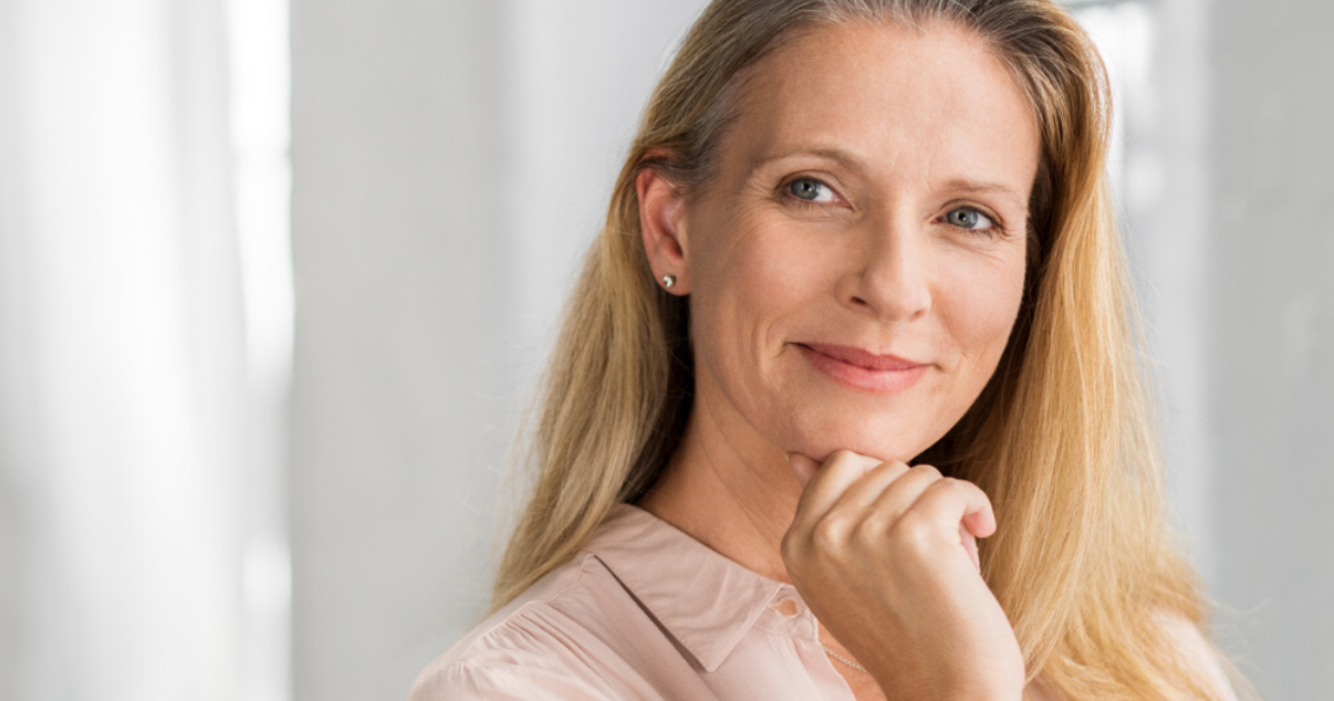 Middle aged woman wearing best stock hairpiece for women with easy hairpiece maintenance