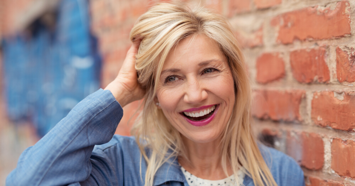 mature woman touching remy stock hairpiece hair system cleaned using hairpiece maintenance techniques