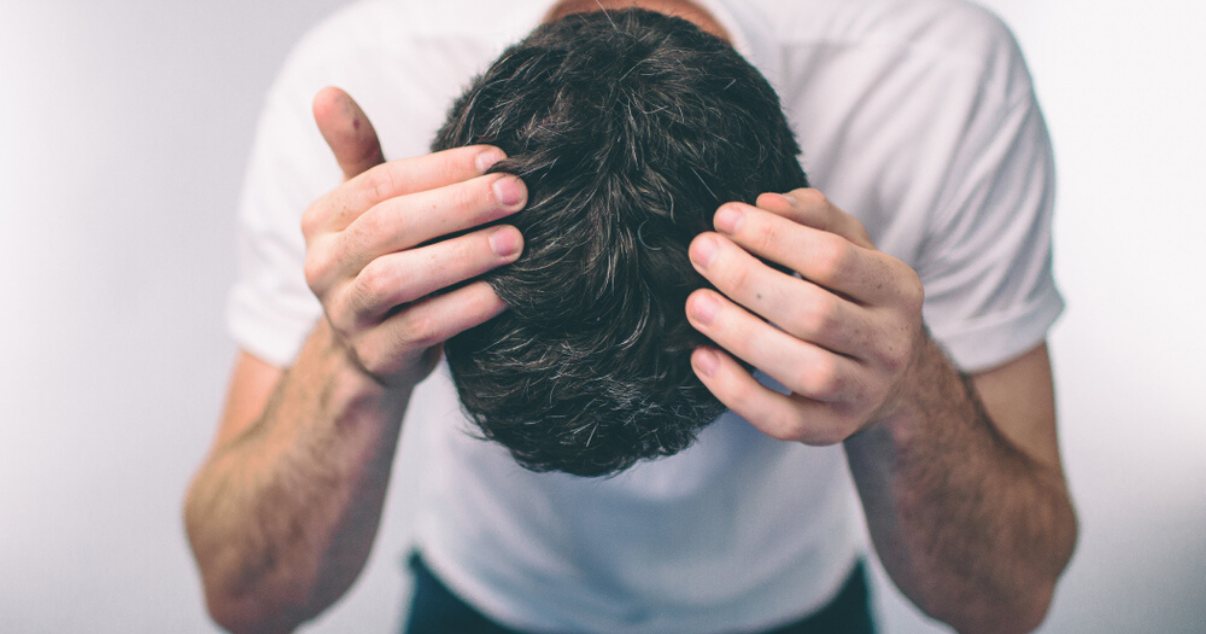 middle aged man applying hairpiece after preparing scalp