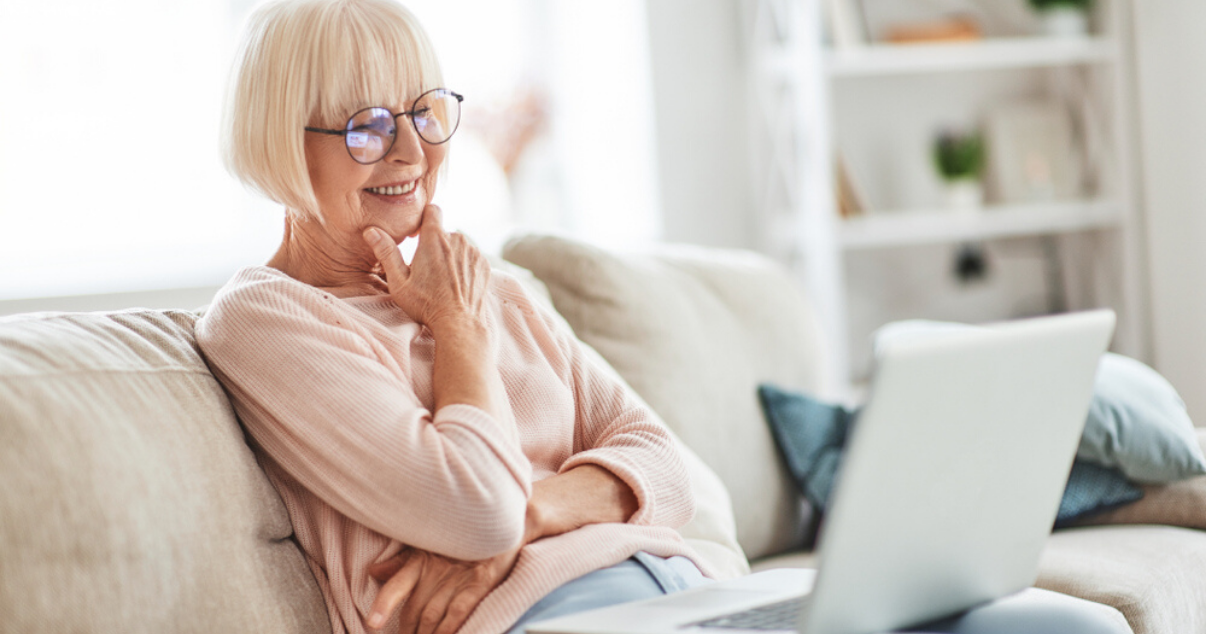 older woman reading guide on hairpiece application and scalp application