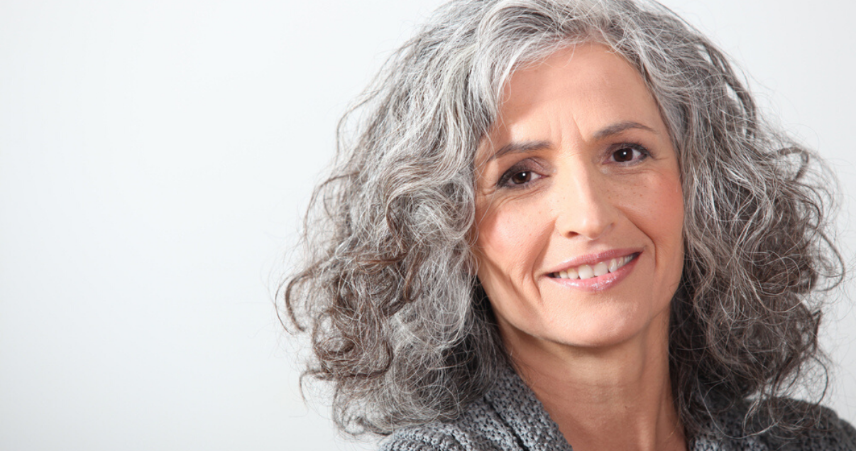 Senior woman wearing best hairpiece hair replacement system