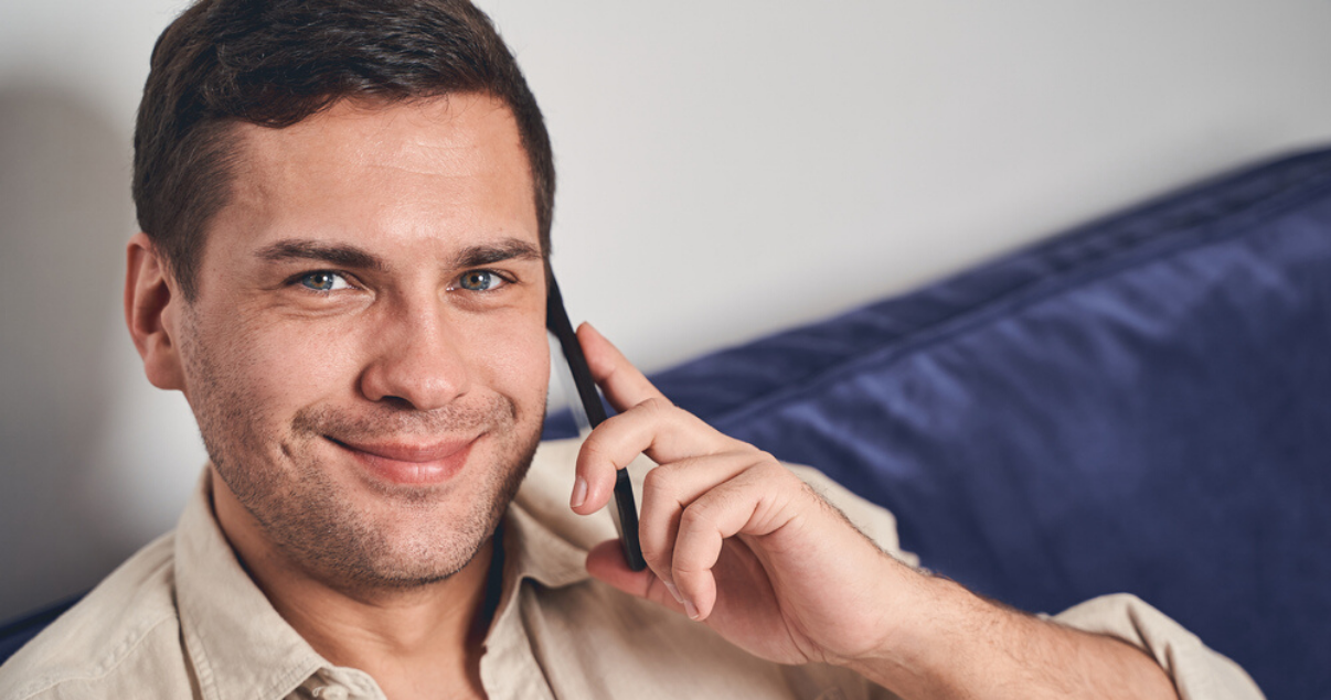 Middle aged man with short hair system for men on phone