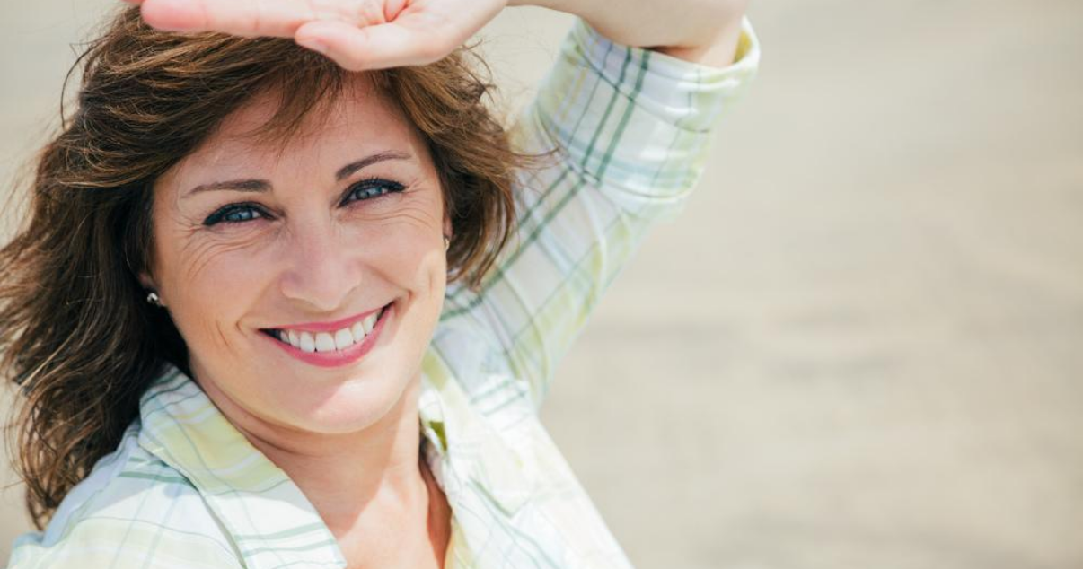 Middle aged woman in the sun with good hair system maintenance