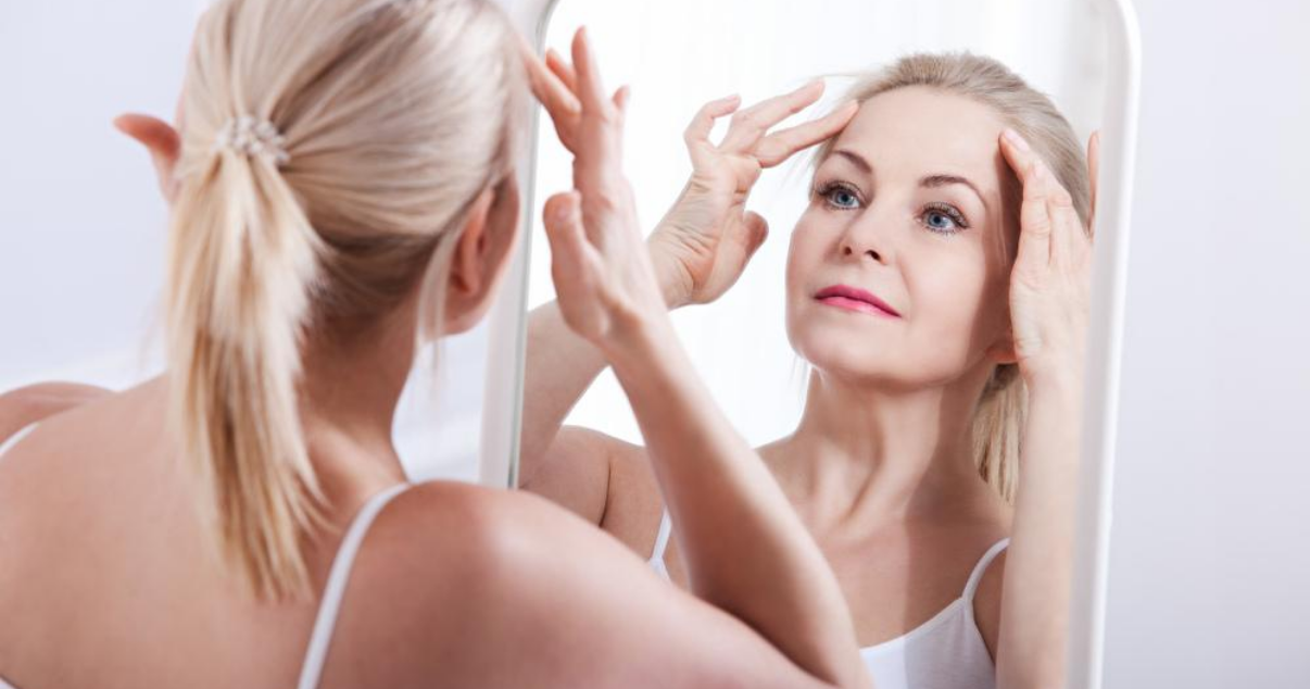 Middle aged woman in bathroom prolonging hair system lifespan