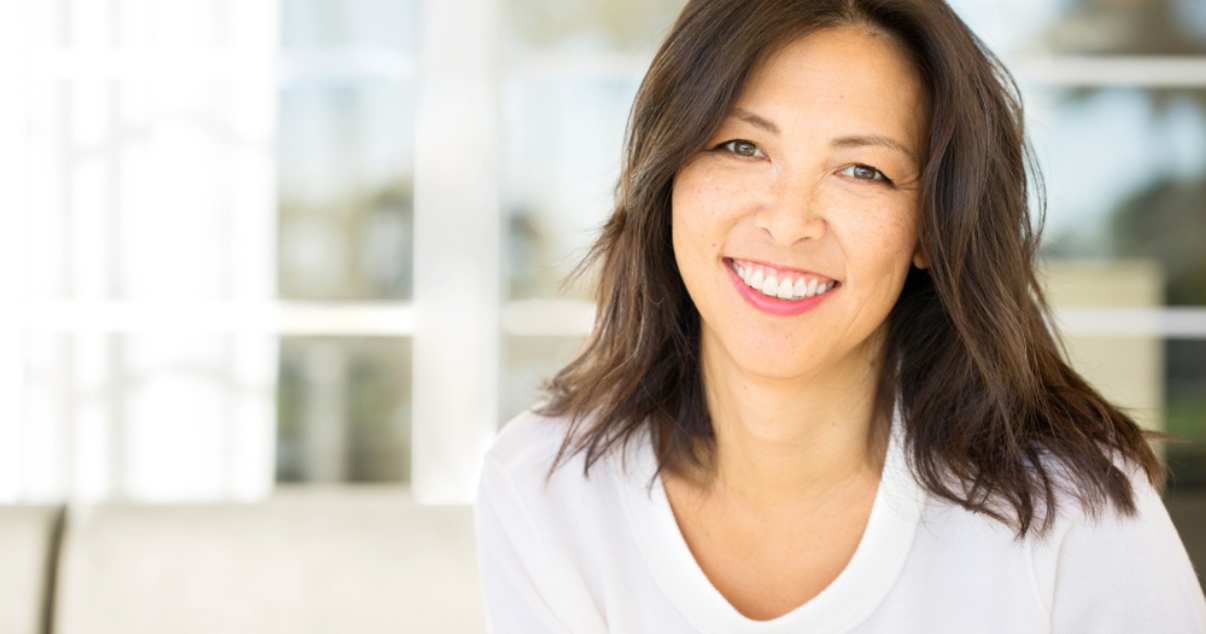 Brunette smiling woman wearing hair system