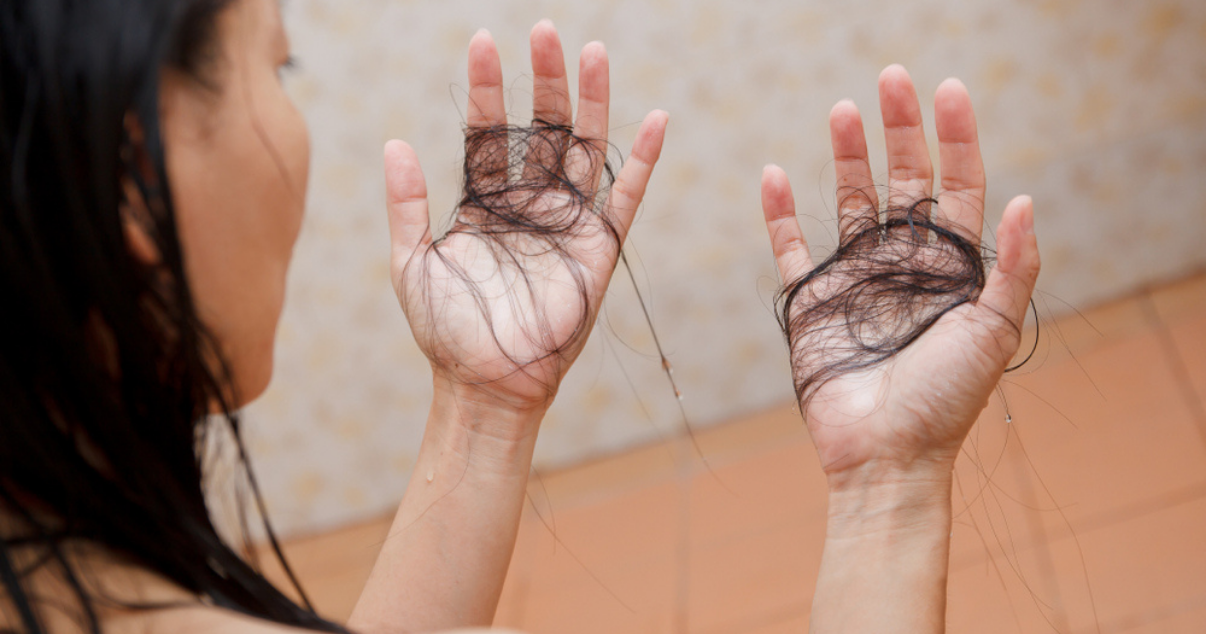 Mature woman with hair falling our of hair system