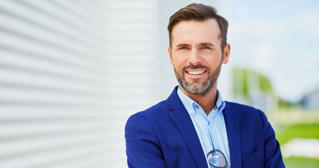 Portrait of a handsome businessman wearing a toupee for men