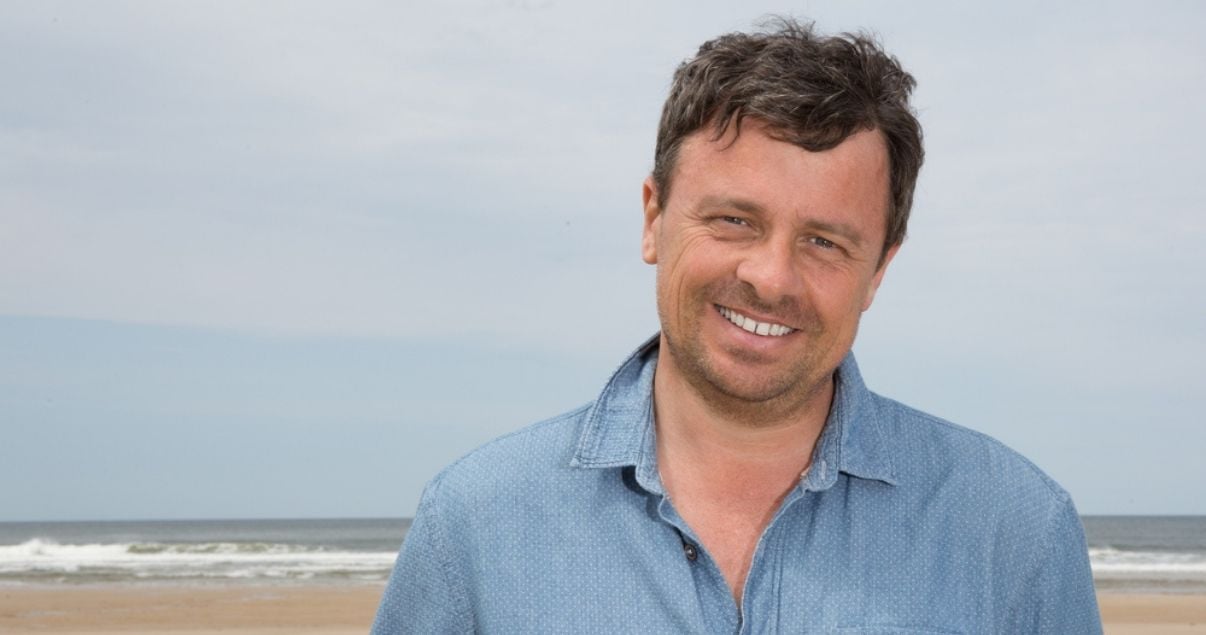 Portrait of middle aged man at beach wearing a toupee for men