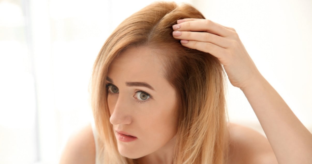 Woman attempting to remove wig glue