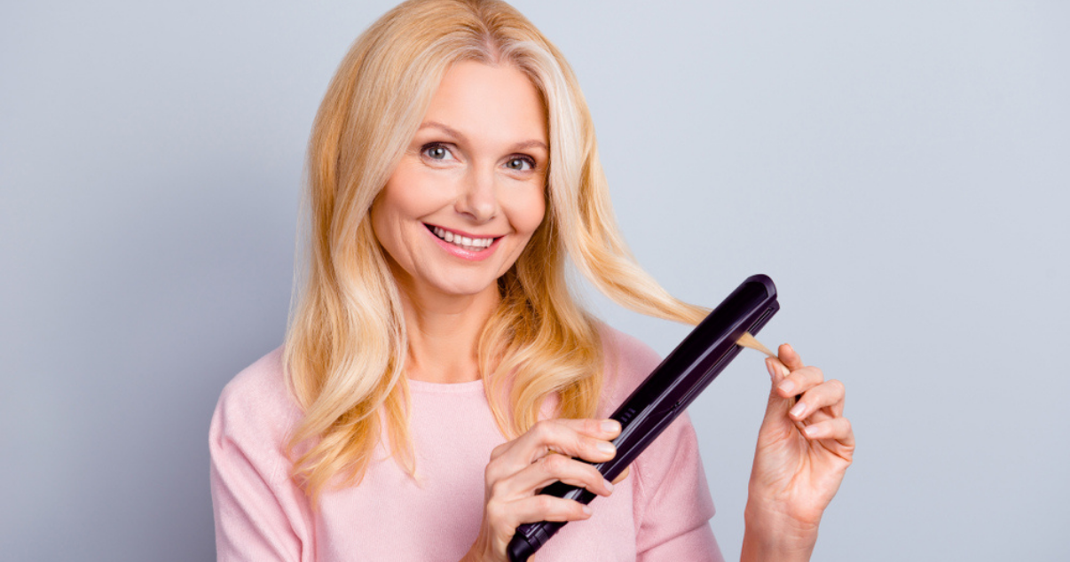 Blonde woman straightening hair system