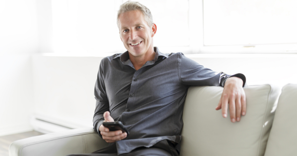 Happy man buying hairpieces online to start fresh the spring