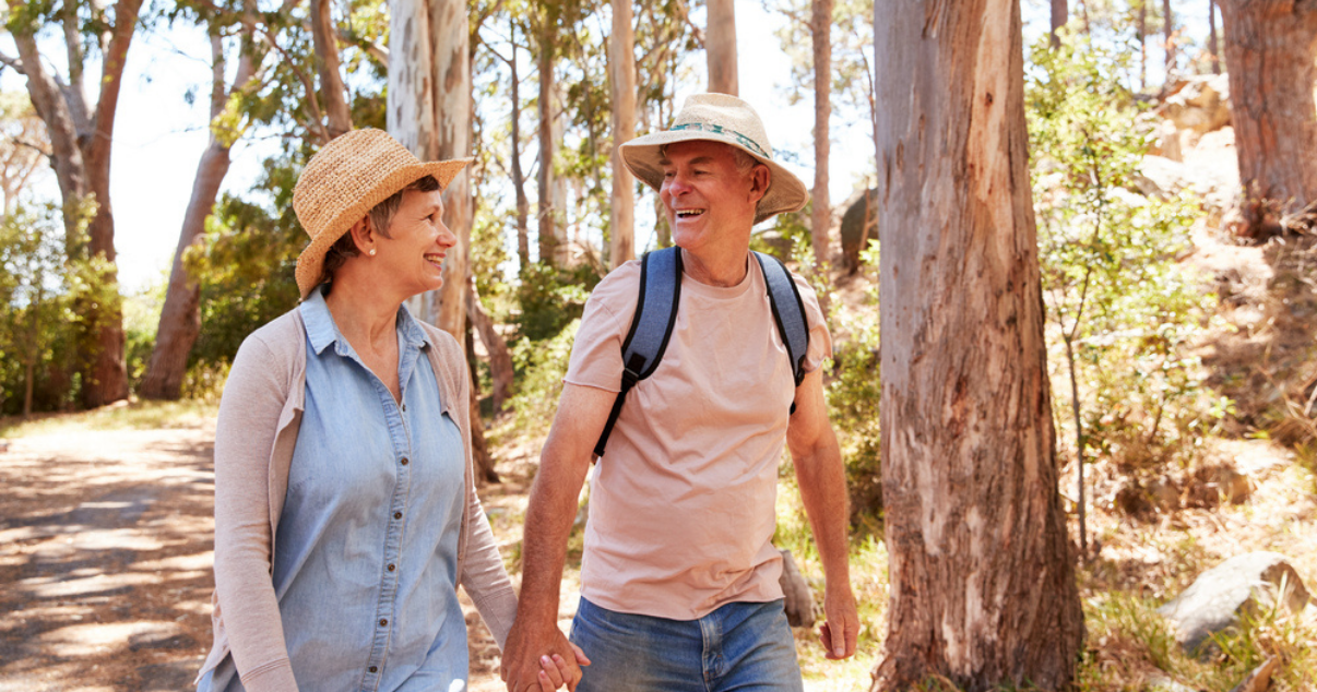 Lovely senior couple using hats during hiking to protect their scalps