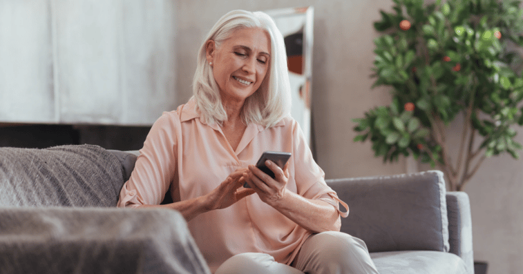 Mature woman using smartphone for buying wigs online