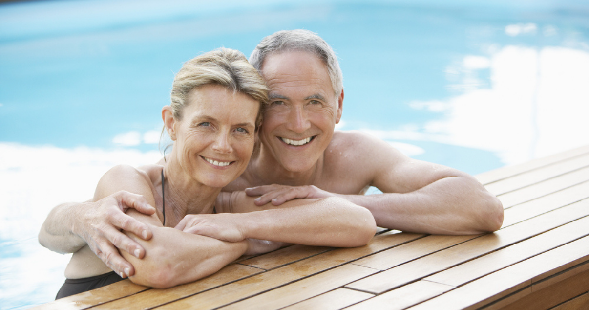 Middle age couple appreciating they bought hair replacement system and they dont have to worry about it getting wet.