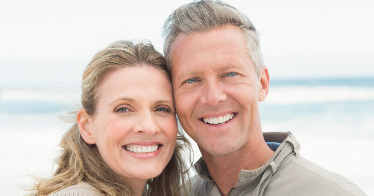 Middle age couple in the beach happy they dont depend anymore on a hair studio (1)