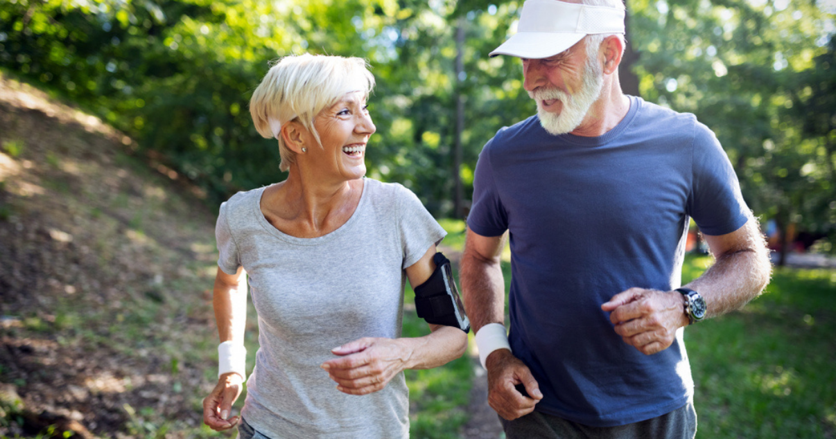 Middle age couple out for a run together while they wear their hair systems