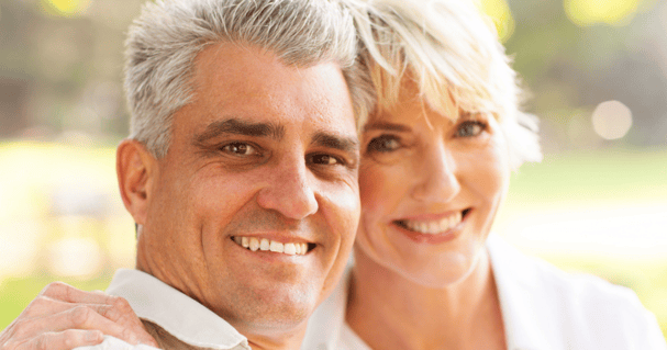 Middle age couple smiling with their hair system