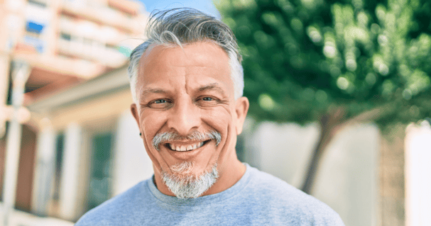 Middle age man happily wearing his hairpiece for men