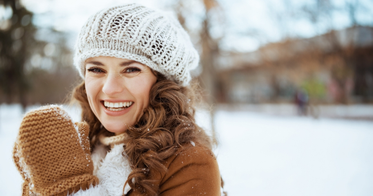 Middle age woman enjoying snow while wearing her hair system