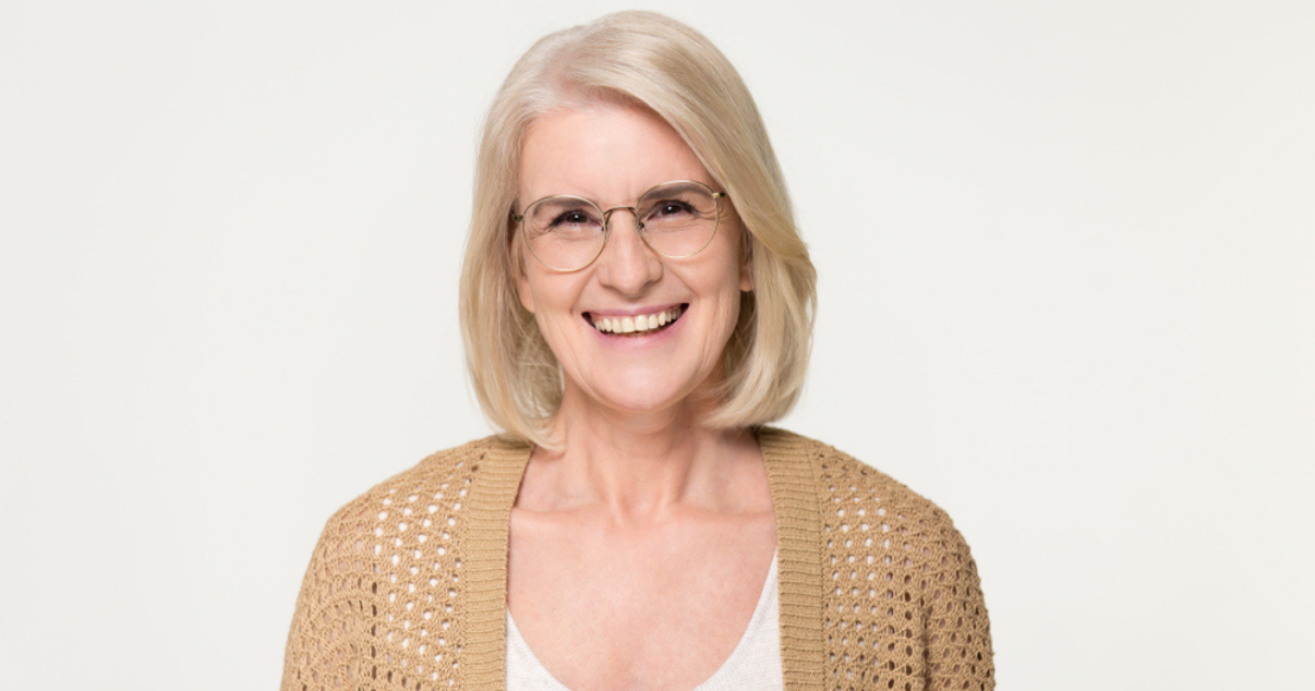 Middle aged blonde woman wearing human hair wig