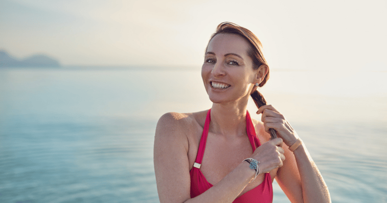 Middle aged woman doing hair system maintenance 