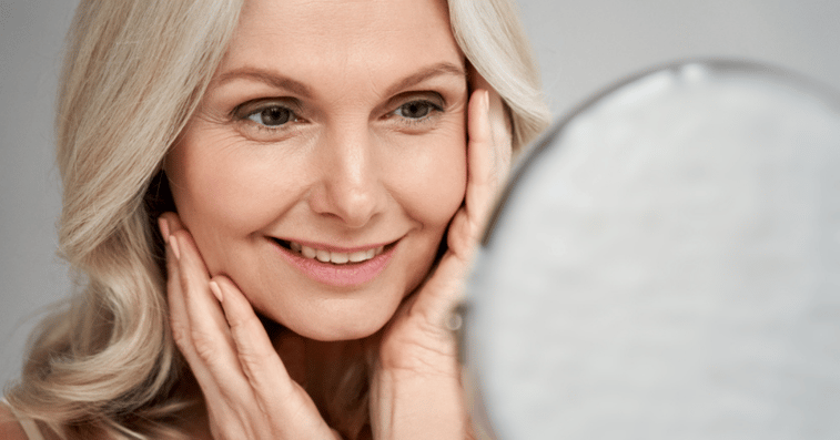 Middle aged woman doing hair system maintenance in bathroom