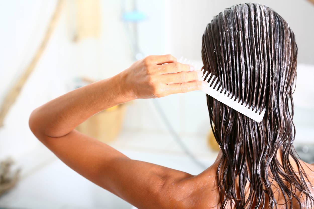 Woman showering while using a Hair System