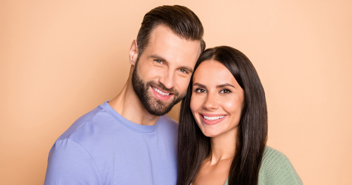 Young and happy couple wearing hair systems