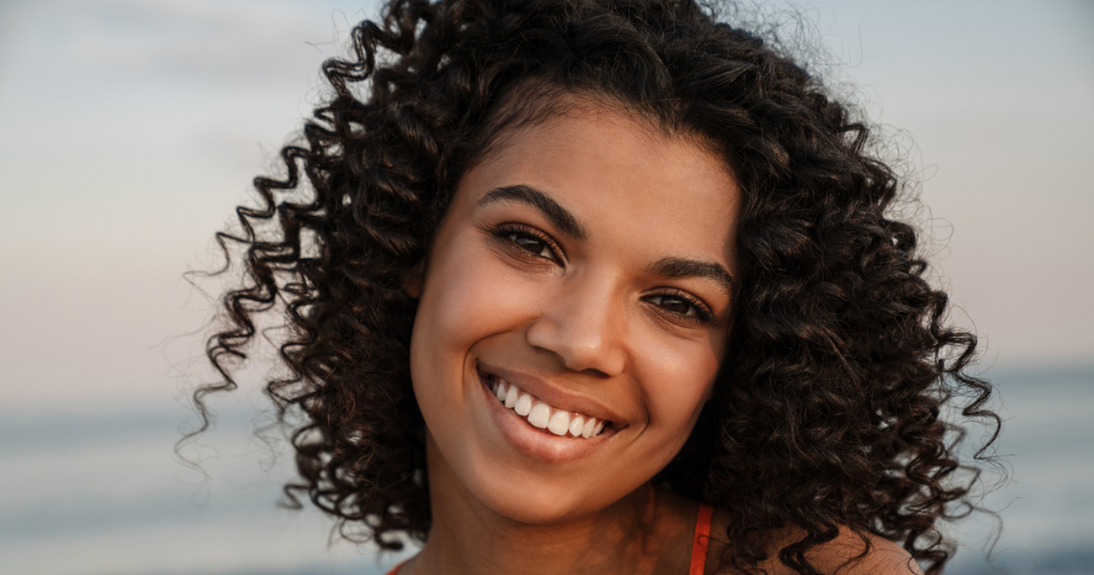 Young girl happy that she doesnt have to worry about getting hair damage from the sun (1)