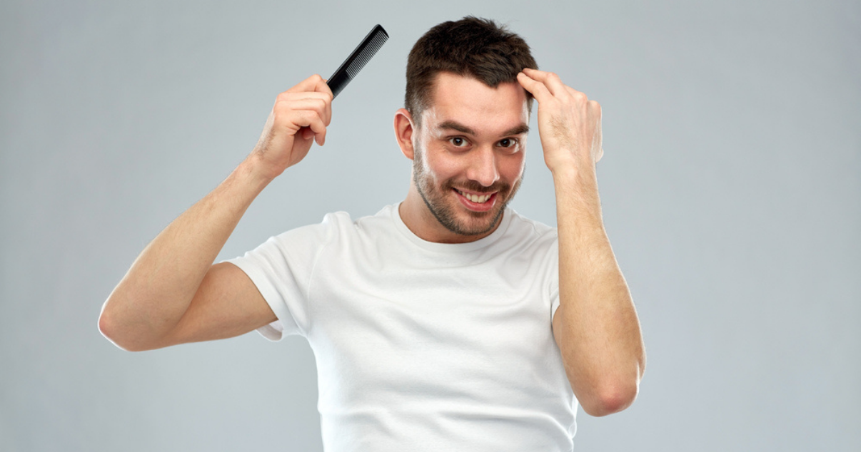 Young man combing his hair