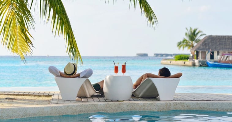 man and woman relaxing at the coast side not worrying about swimming with their hair system.