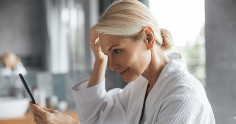 middle_aged_woman_attaching_hair_system_with_liquid_adhesive_hair_piece_maintence