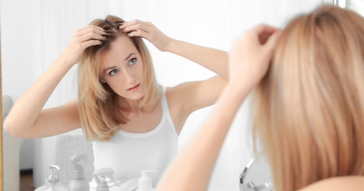 woman fixing french lace hairpiece attachment