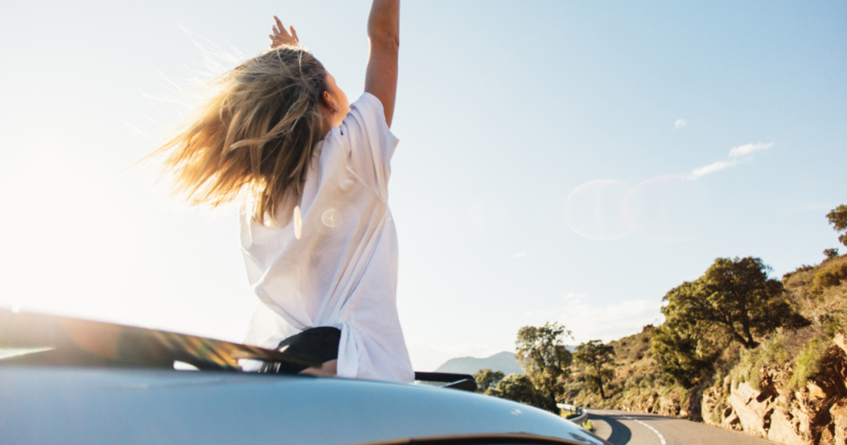 woman riding a car with her hairpiece in the summer wind (2)