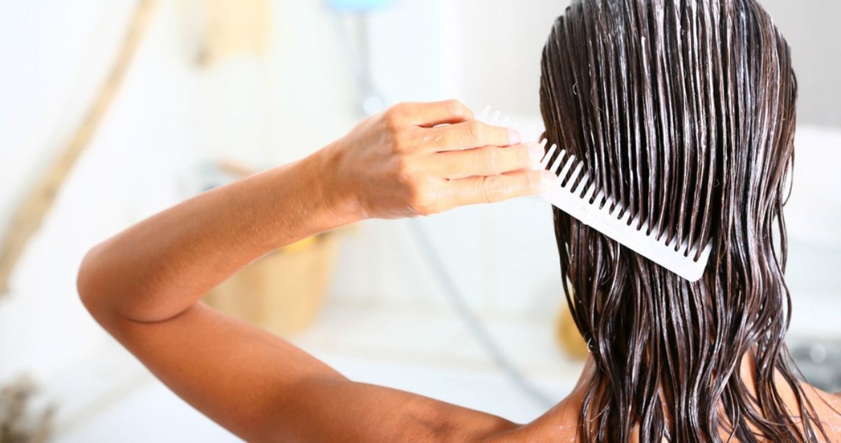 woman_brushing_hair_care_product_in_wet_hair