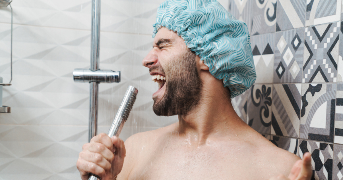 Man showering with his hairpiece