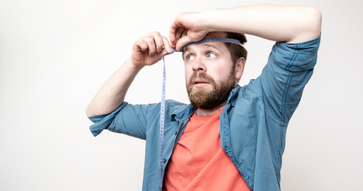 Man trying to measure his scalp