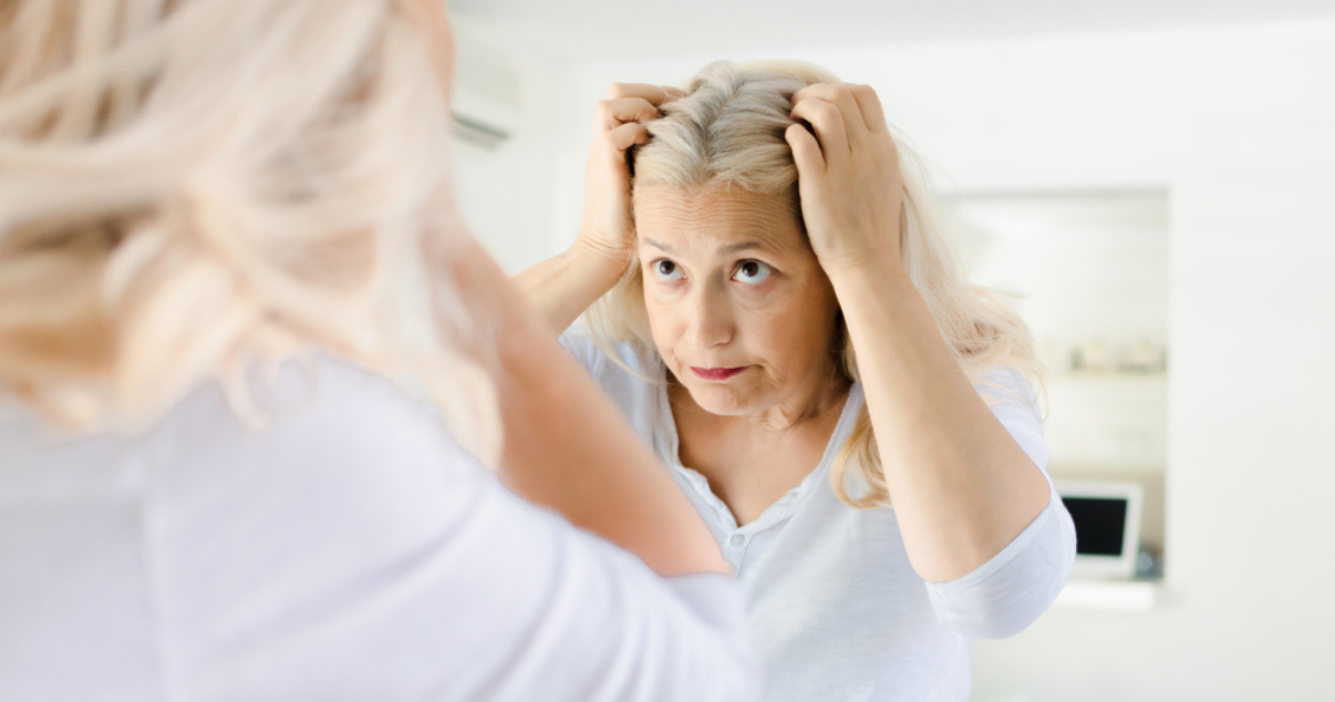 Senior woman deciding if she should restore her hairpiece