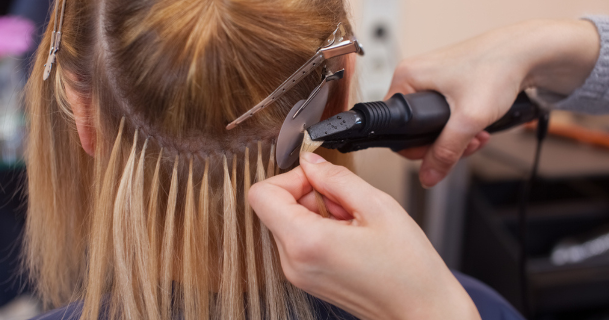 Woman putting on her hair extensions